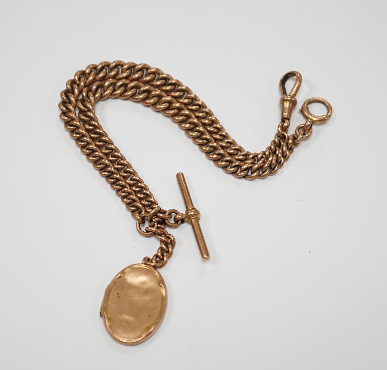 An Edwardian 9ct gold graduated curb link albert, 35cm, hung with a 9ct gold locket, gross 48.6 grams.
